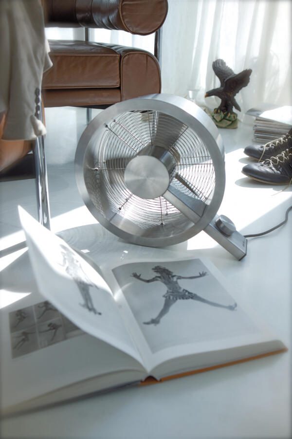 Ventilator Q aufgestellt in einem modernen Wohnraum, demonstriert seine Funktionalität als Kunstwerk und Kühlgerät.