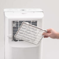 Luftfilter für TTK 65 E Luftentfeuchter: Ein Mann wechselt den weißen Filter. Wartung für optimale Leistung und saubere Luft im Raum.